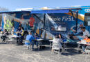 A photo of CPS Energy bill advisors working with customers at a mobile event